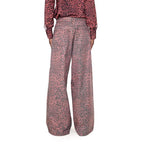 A pair of pink high-waisted straight wide jeans with an animal print pattern.