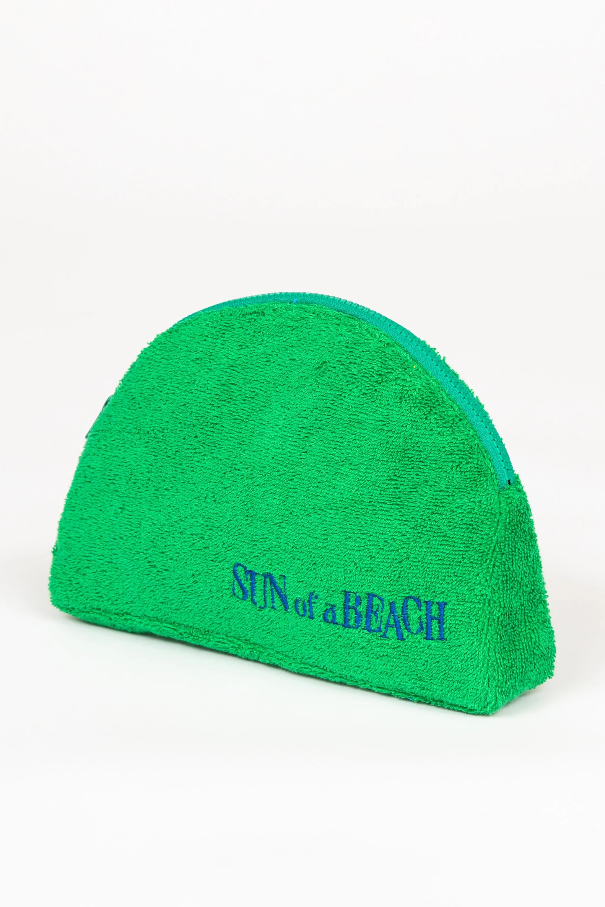 Green towel with 'Sun of a Beach' text on a white background