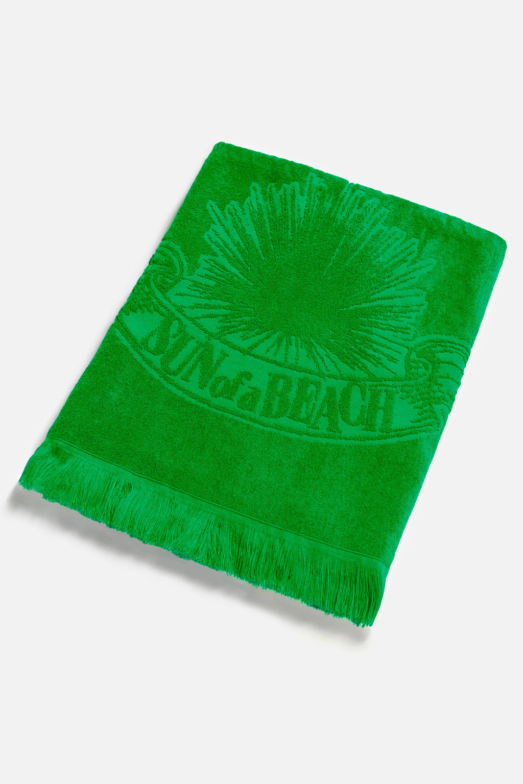 Green beach towel with a sun design and 'On the Beach' text on a white background