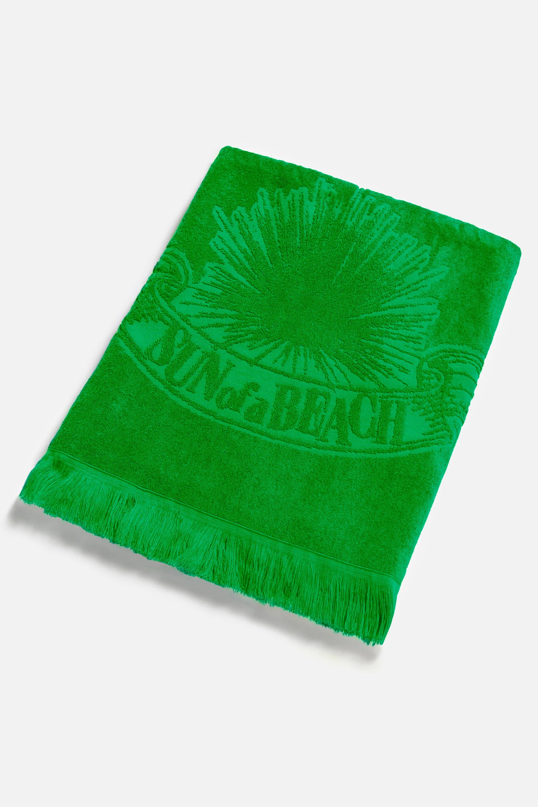 Green beach towel with a sun design and 'On the Beach' text on a white background