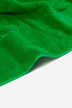 Close-up of a green towel on a white background
