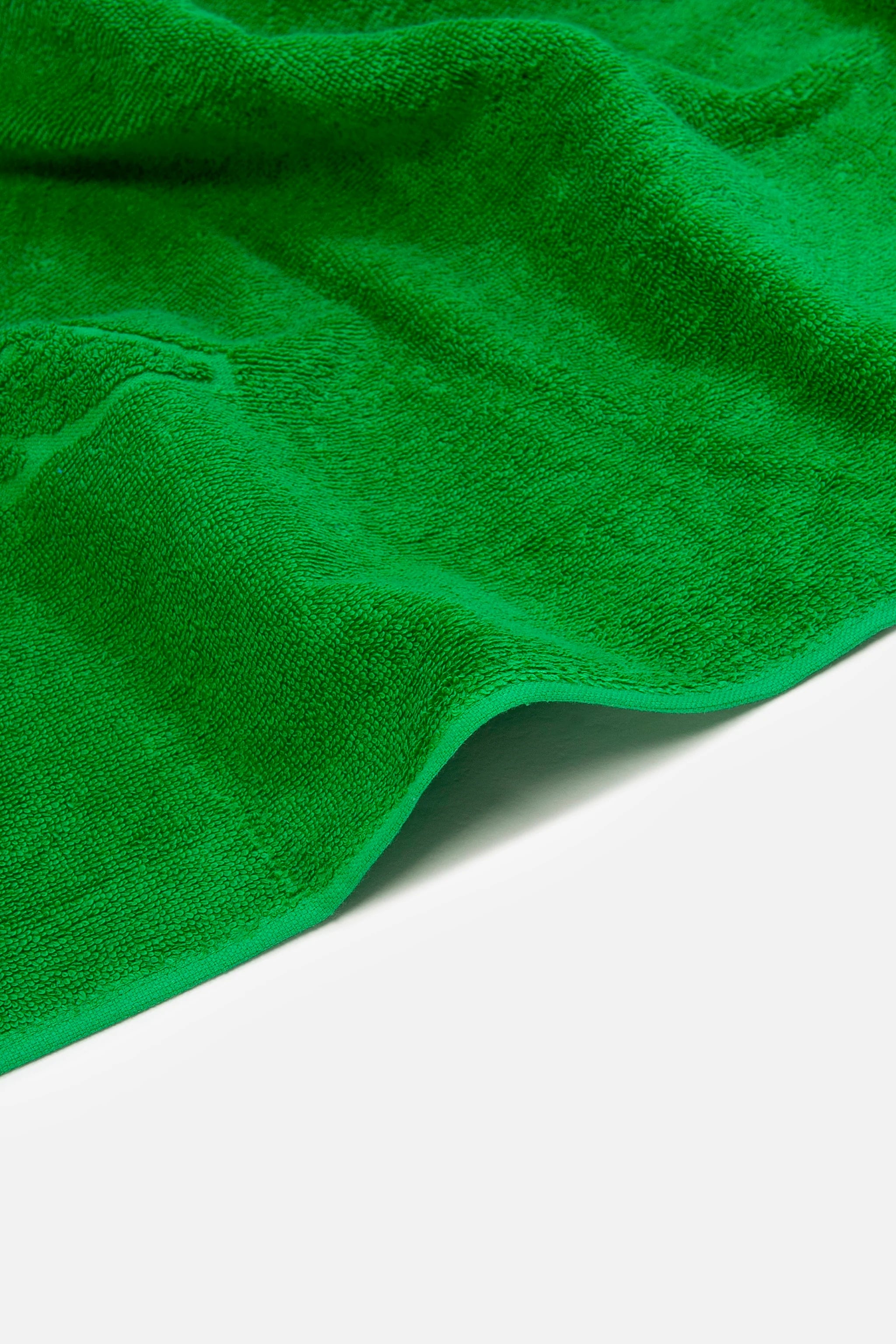 Close-up of a green towel on a white background