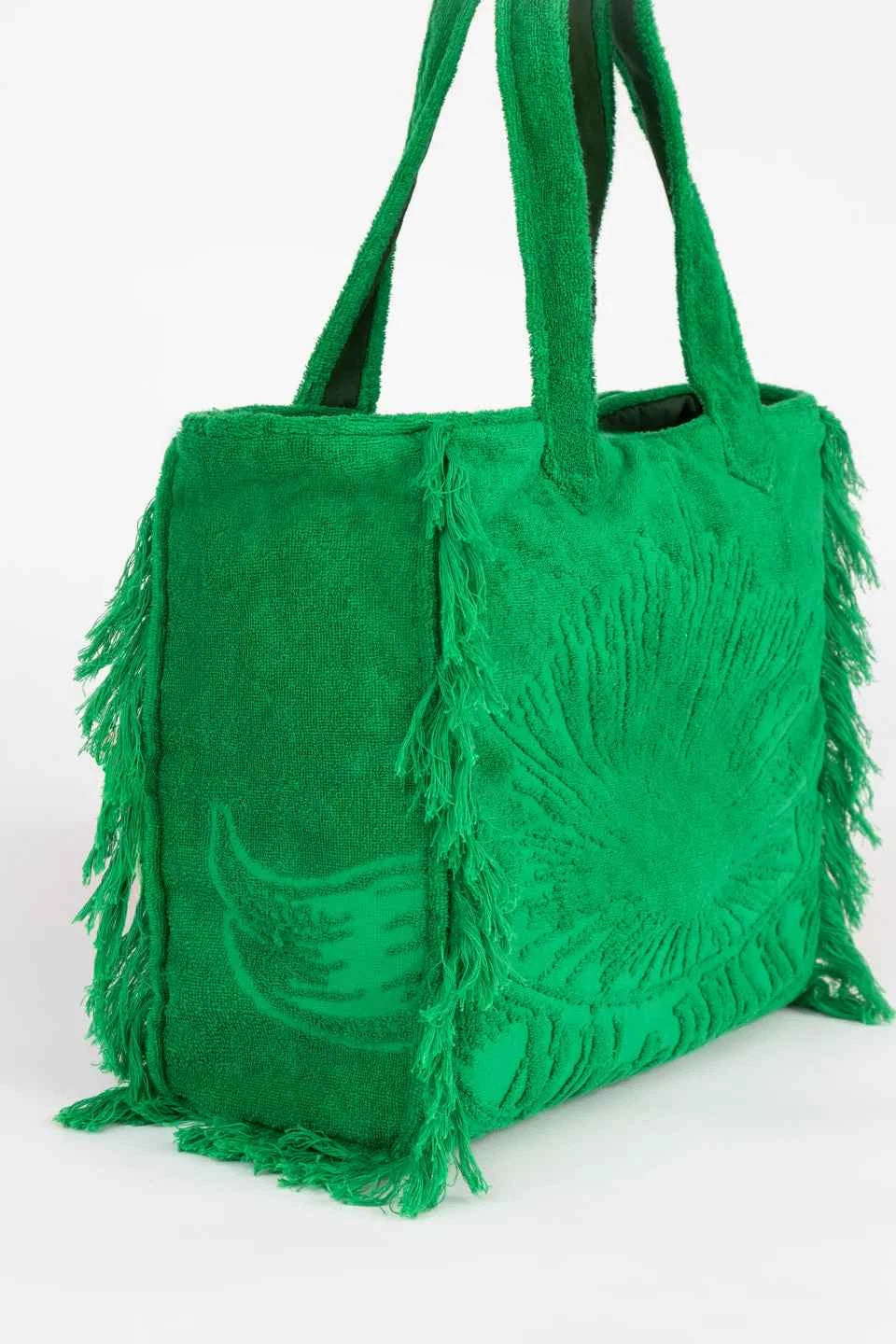 Green handbag with fringe details on a white background