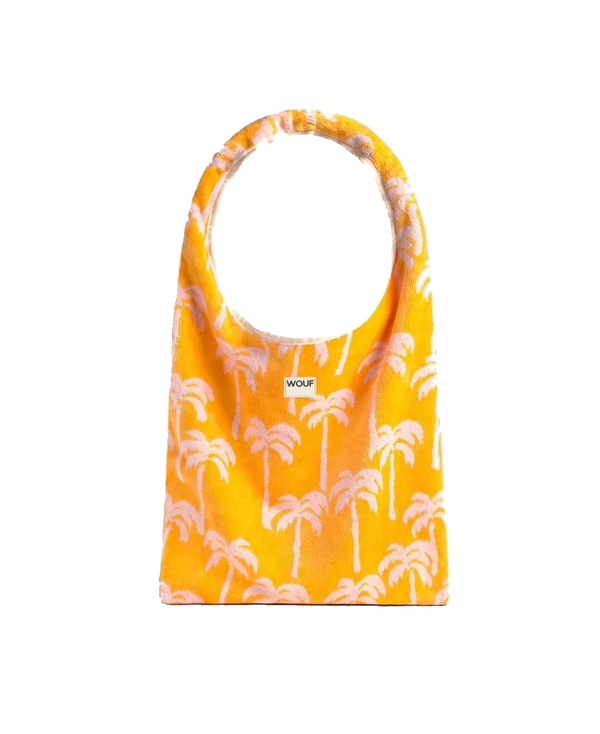 A yellow fabric tote bag with a white palm tree pattern and a small white 'WOUF' brand label on the front, shown against a plain white background.