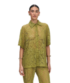 A model wearing a matching olive green lace short-sleeve button-up shirt and trousers set, photographed against a solid white background.
