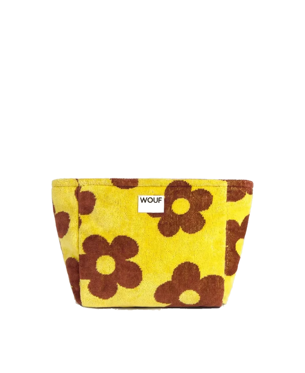 A yellow fabric pouch with a retro brown daisy pattern, featuring a small white label with the brand name 'WOUF' on the front, set against a plain white background.
