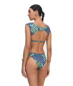 A woman modeling a two-piece bikini from the back, featuring a navy blue and white polka dot pattern with green tropical leaf prints, set against a plain white background.