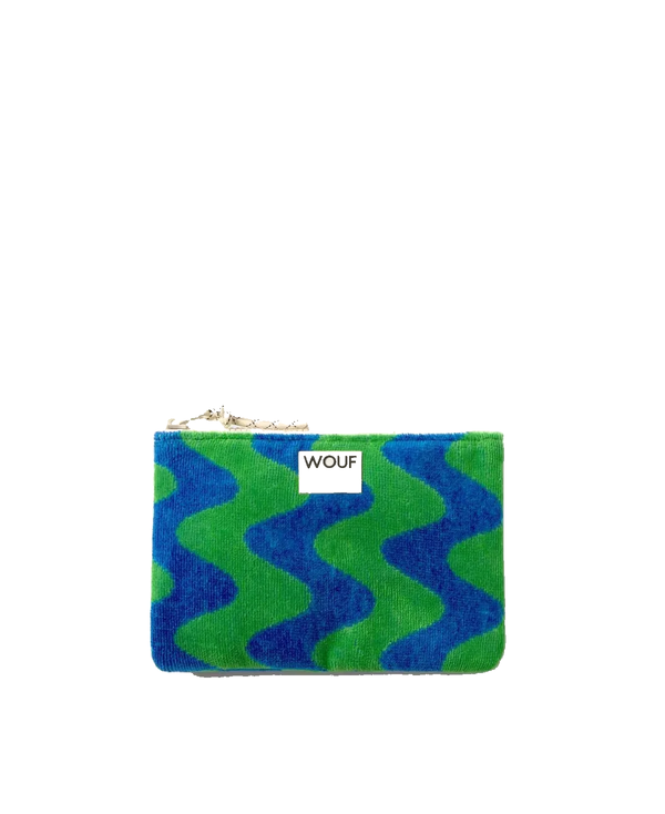 A small zippered pouch with a blue and green wavy pattern, featuring a white label with the brand name 'WOLF' and a gold zipper pull, set against a plain white background.