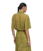 A woman shown from the back wearing a matching olive green lace top and skirt set, photographed against a plain white studio background.