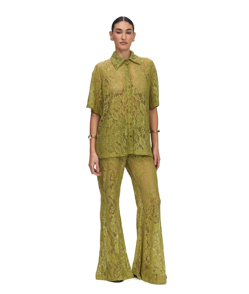 A model wearing a matching olive green lace two-piece set consisting of a short-sleeve button-up shirt and wide-leg pants, photographed against a solid white background.